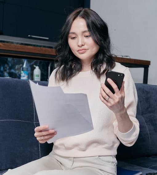 Woman reviewing a medical bill on her phone